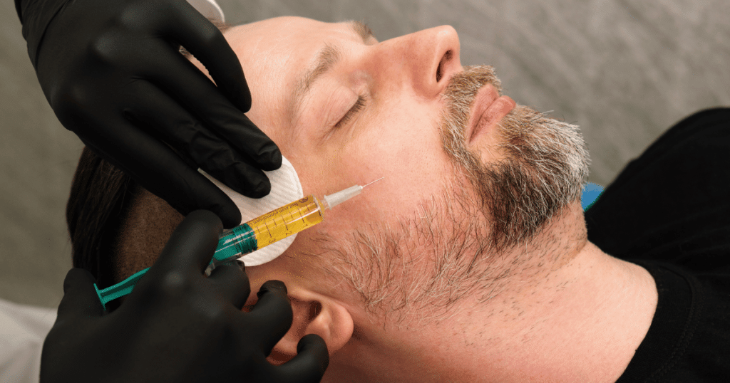 Man receiving PRP facial treatment for skin rejuvenation.